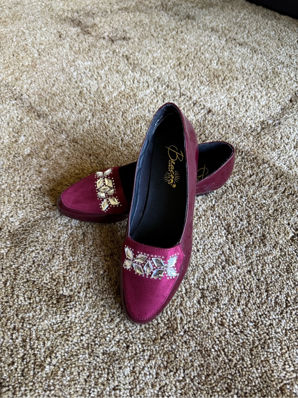 Burgundy Beacon loafer heels with leather and rhinestone details on the toe